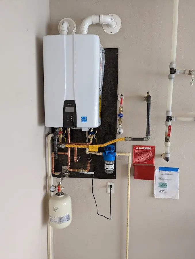 Professional plumber installing copper piping in a Pearl River home